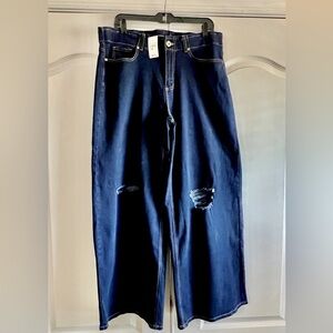 On trend: A wide leg dark rinse jeans—tags on and never worn